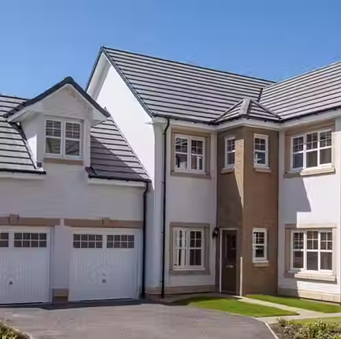 Home with a brick and white exterior, featuring a landscaped garden and two garage doors