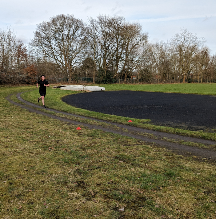 Man running round track