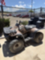 Polaris Xpedition 325 4x4 ATV side view with front cargo rack and rear storage box