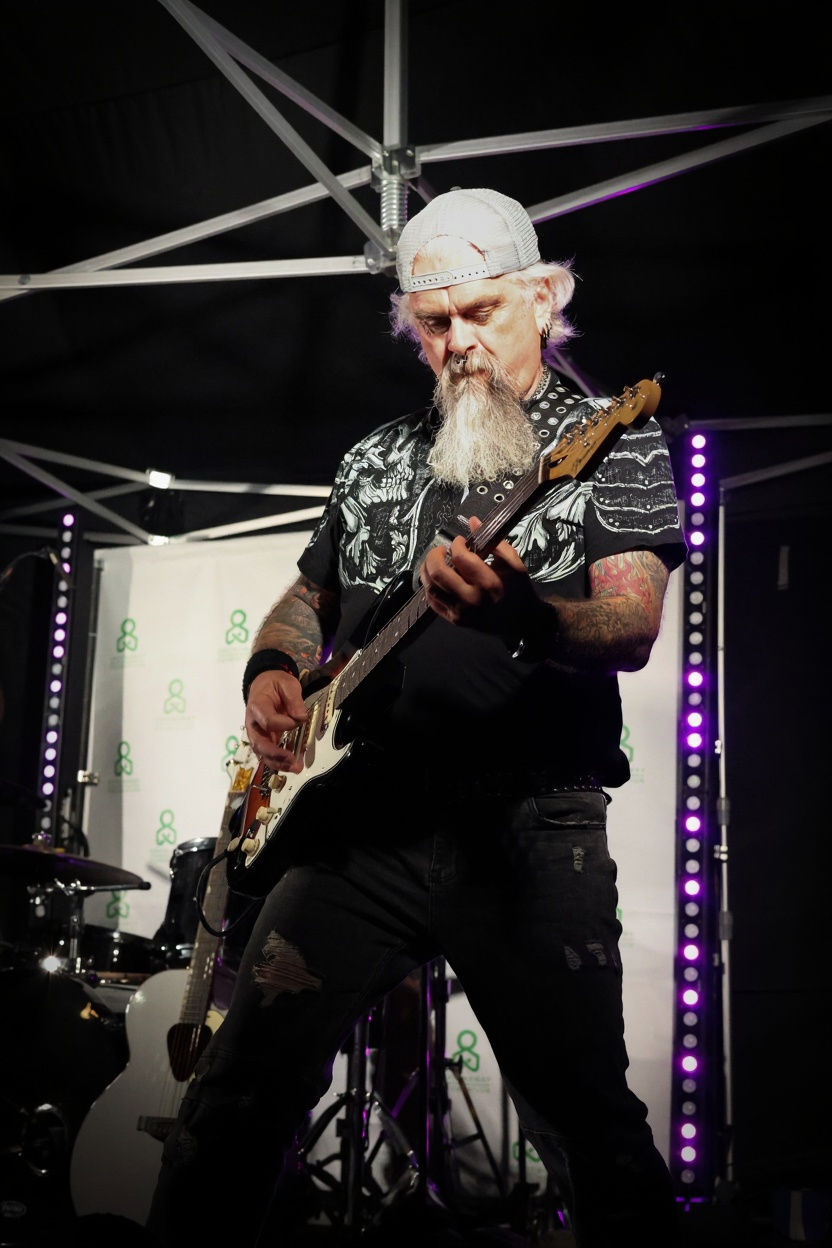 Band member playing guitar