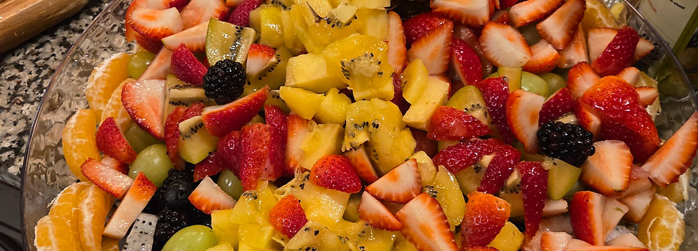Large fresh fruit platter with pineapple centerpiece, colorful, vibrant event display.