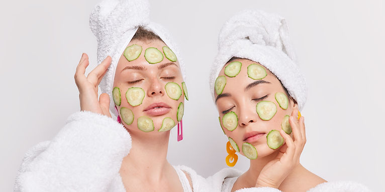portrait-two-mixed-race-women-stand-with-closed-eyes-apply-cucumber-slices-face-moisturize