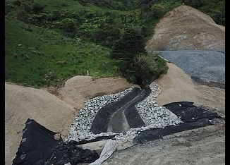 Curved rock-lined channel constructed for controlled water diversion