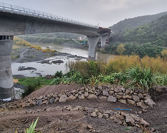 Rock armouring and scour protection works beneath bridge over waterway