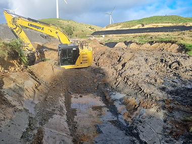 Excavator carrying out bulk earthworks in wet ground conditions