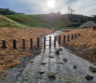 Stabilised waterway with shaped banks and sediment control measures