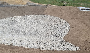 Rock-lined drainage channel with sediment controls during earthworks