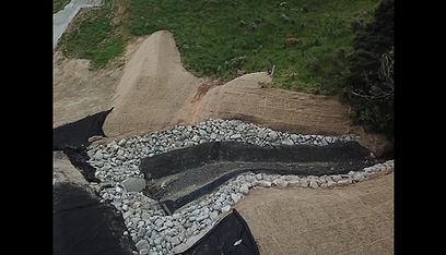 Geotextile-lined drainage channel with rock for sediment and erosion control