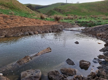 Stabilised water channel with erosion protection and rock lining