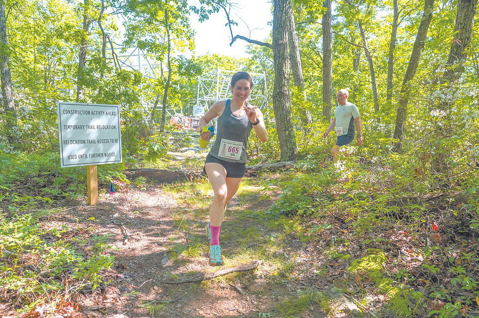 Jessica Gallagher of Waccabuc passes by the fire tower under construction atop Cross River Mountain.