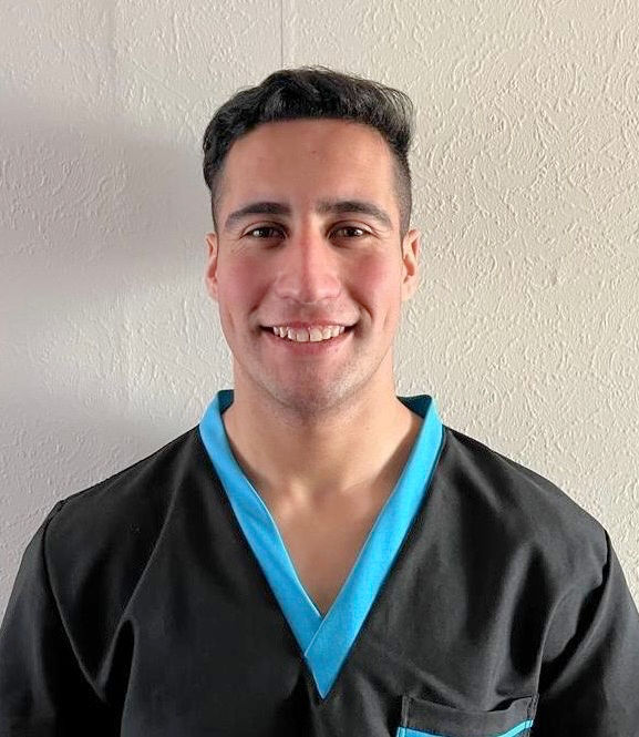 Close-up view of massage oils and stones arranged neatly on a wooden tray