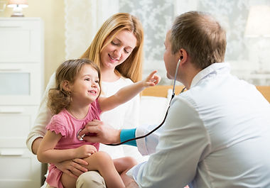 Male Pediatrician examining cute little girl