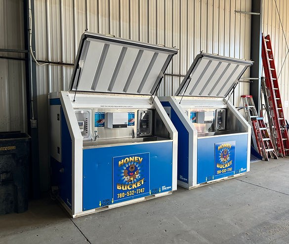 Two blue and white refrigerators displayed in a large warehouse environment.