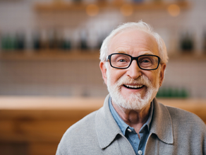 Portrait of a senior adult wearing glasses and smiling.