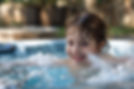 little girl is enjoying in hot tub