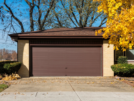 Residential garage door with autumn trees