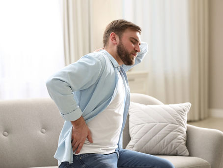 A young man is experiencing lower back pain