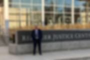 Client standing in front of a courthouse building_edited.jpg