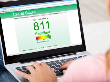 A person checking his credit score on a laptop.
