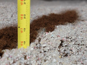 Measuring ruler inserted into insulation to show insulation depth