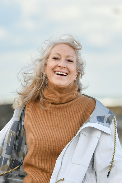 Portrait of a sixty-year-old woman with a snow-white smile