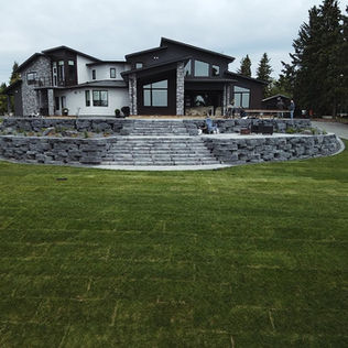 A spacious residence surrounded by a stone wall
