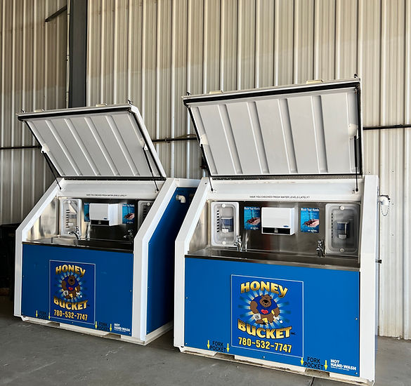 A warehouse featuring two blue and white refrigerators arranged next to each other.