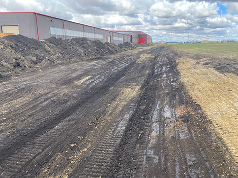 Muddy access road at an active construction site