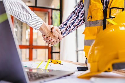 A construction worker shaking hands with a person