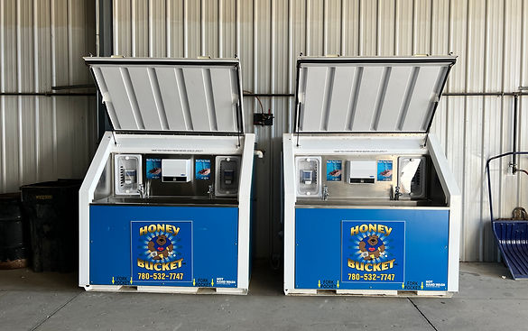 Two blue and white vending machines with open doors, displaying various snacks and drinks inside.
