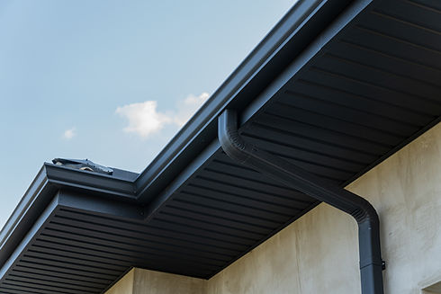 Clean dark grey aluminum eavestrough and downspout drainage system installation