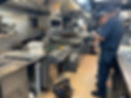 A commercial kitchen with stainless steel equipment and cooking utensils.