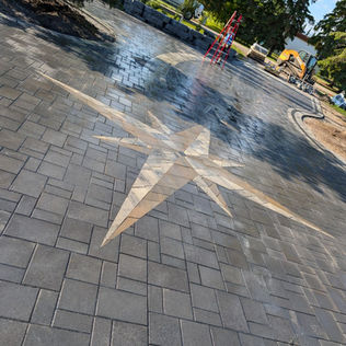 A star-shaped driveway featuring a prominent star design at its center
