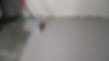 worker applying epoxy coating on concrete floor