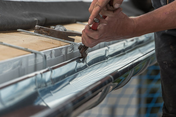 Close-up of a newly installed gutter on a roof