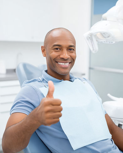 Happy patient sitting in dental chair smiling .jpeg