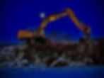 A large excavator rests atop a snow pile, showcasing its massive size against the white winter lands