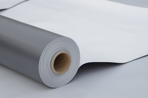 Roll of grey commercial flat roofing membrane material ready for installation