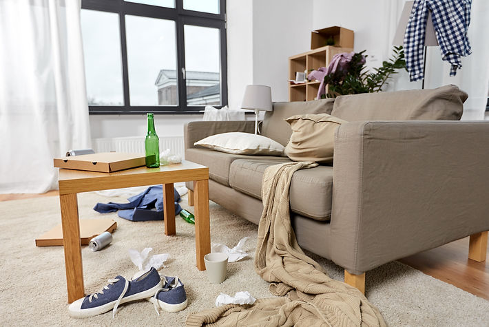 mess, disorder and interior concept - view of messy home living room with scattered stuff.