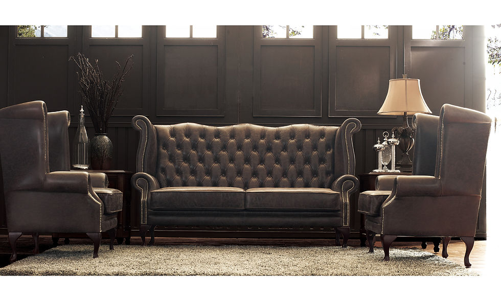 Luxurious brown leather sofa and chairs in an elegant room with dark paneled walls, a vase, lamp, and carpet, creating a cozy ambiance.