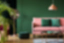 pink sofa with green cushions