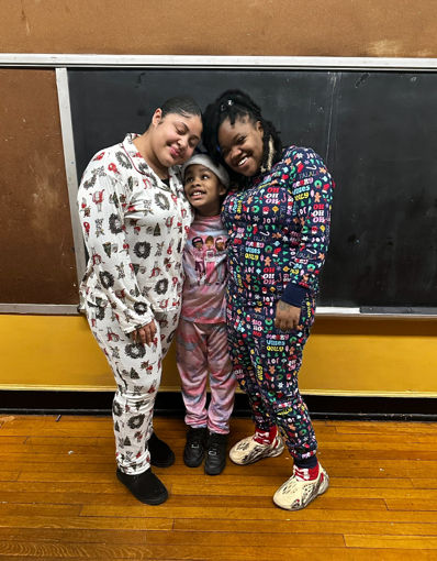 Student and two teachers hugging in holi