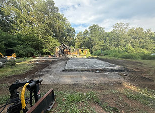 Excavator safely demolishing a small structure for site redevelopment