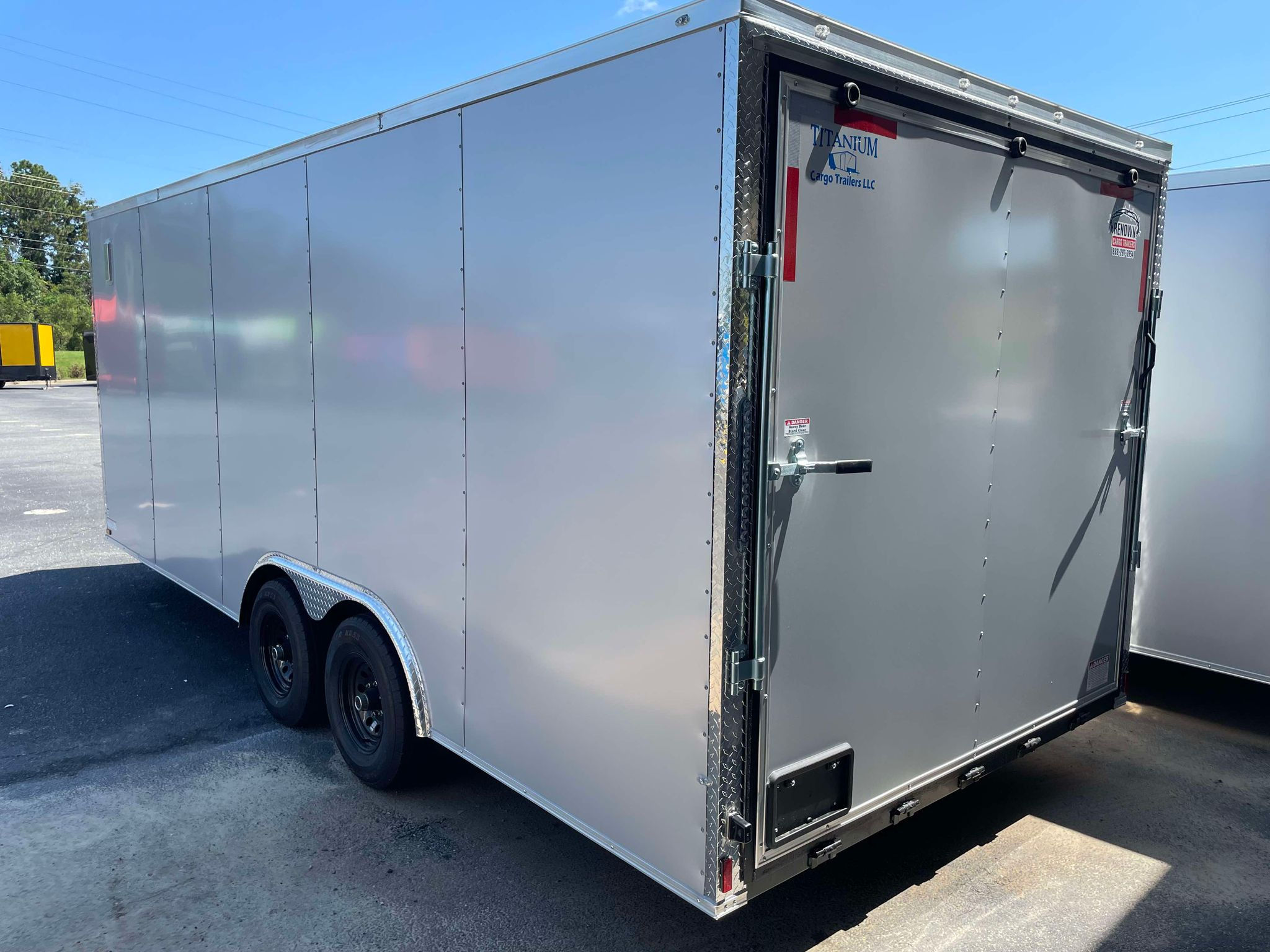 Titanium Cargo 8.5x20 enclosed cargo trailer with Silver Frost polycore exterior, tandem axles, 7-foot interior height, and heavy-duty ramp door for sale.