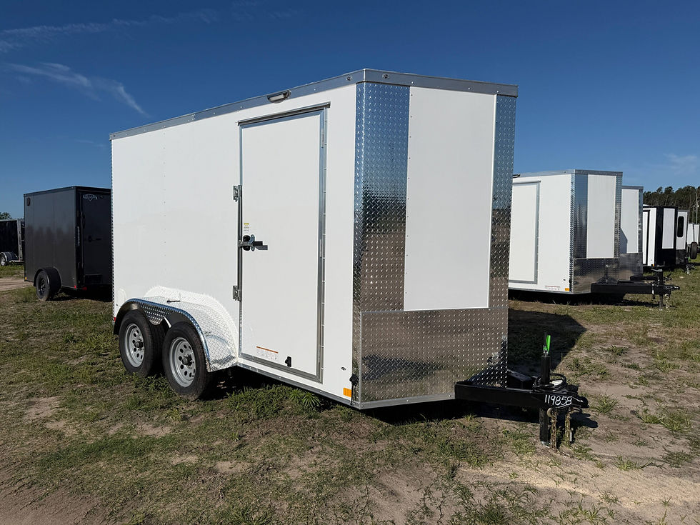 Diamond Cargo 6x12 tandem axle enclosed trailer with 7 foot interior height, Polycore exterior, side door, ramp door, electric brakes, and silver modular wheels.