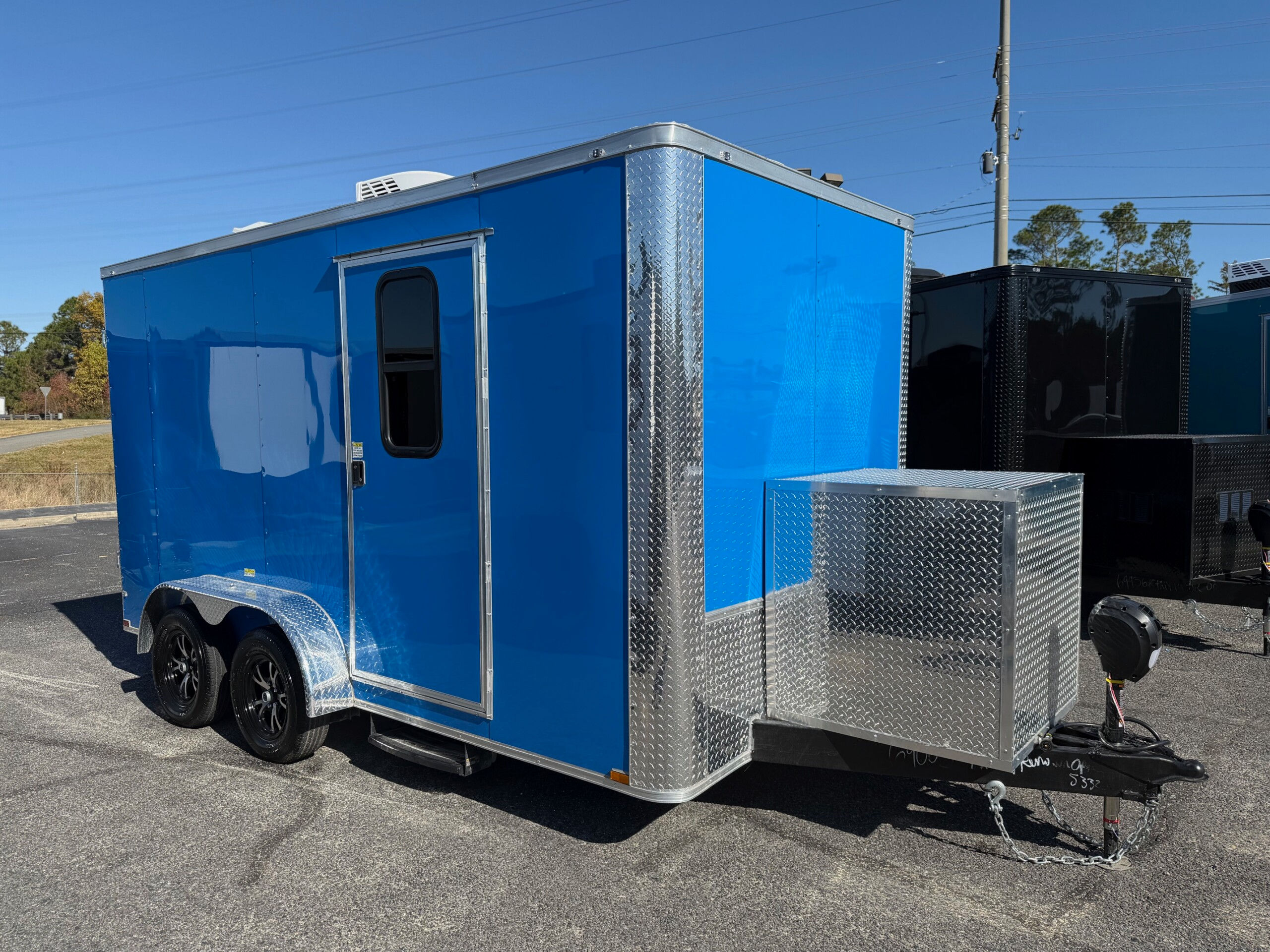 True Blue Genesis Series 7x14 pet grooming trailer with Flying Pig tub, generator compartment, mag wheels, water tanks, and mobile grooming setup.