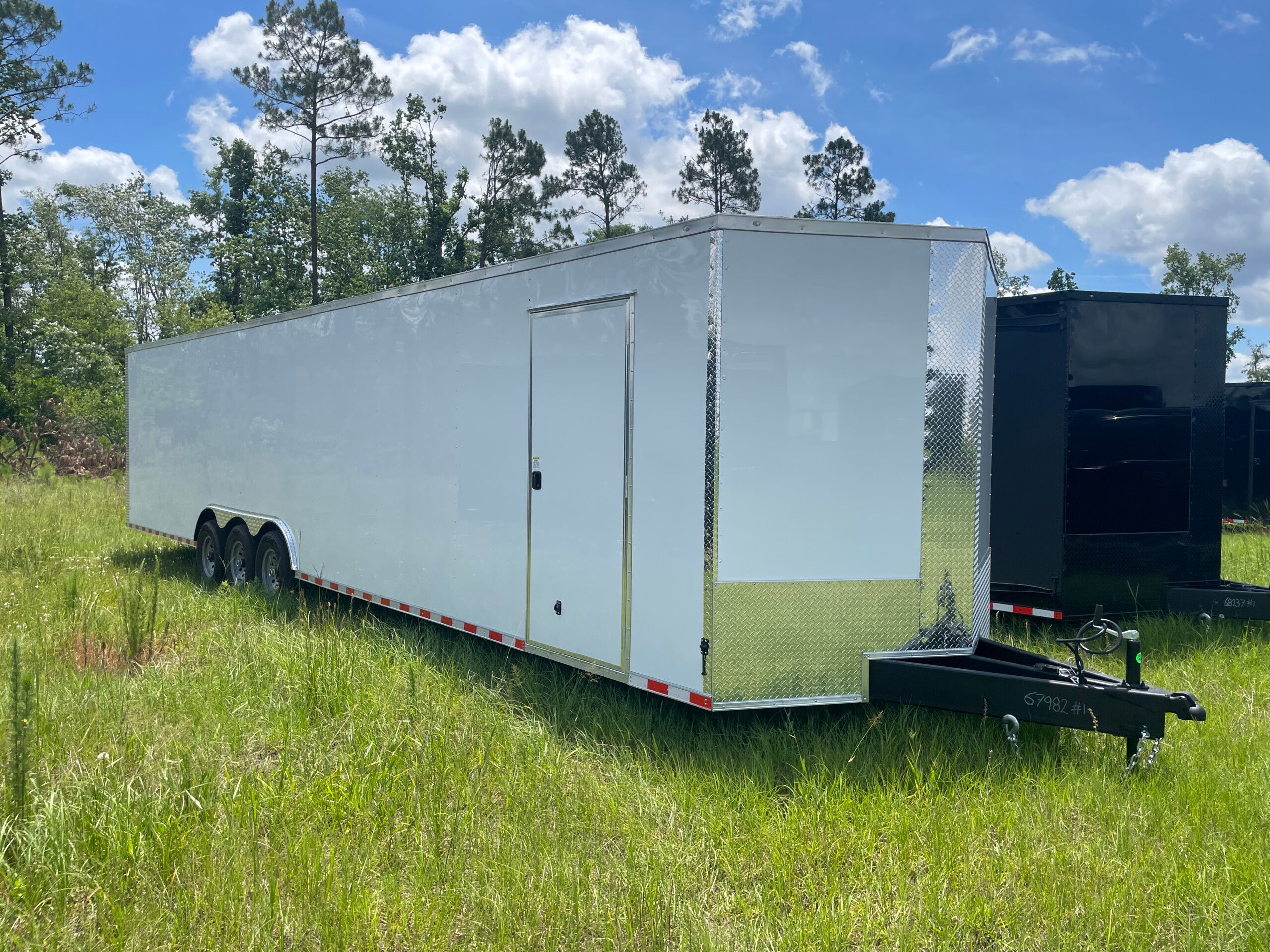 Rock Solid 8.5x36 triple axle enclosed cargo trailer with Polycore semi-screwless exterior, 60-inch extended tongue, triple 7,000 lb axles, and V-nose design.