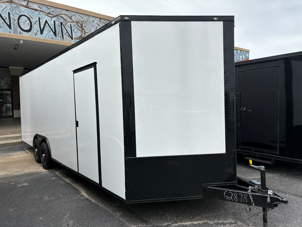 Deep South 8.5x24 white enclosed car hauler trailer with polycore exterior, blackout package, escape door, mag wheels, and tandem 5200 lb axles for sale.