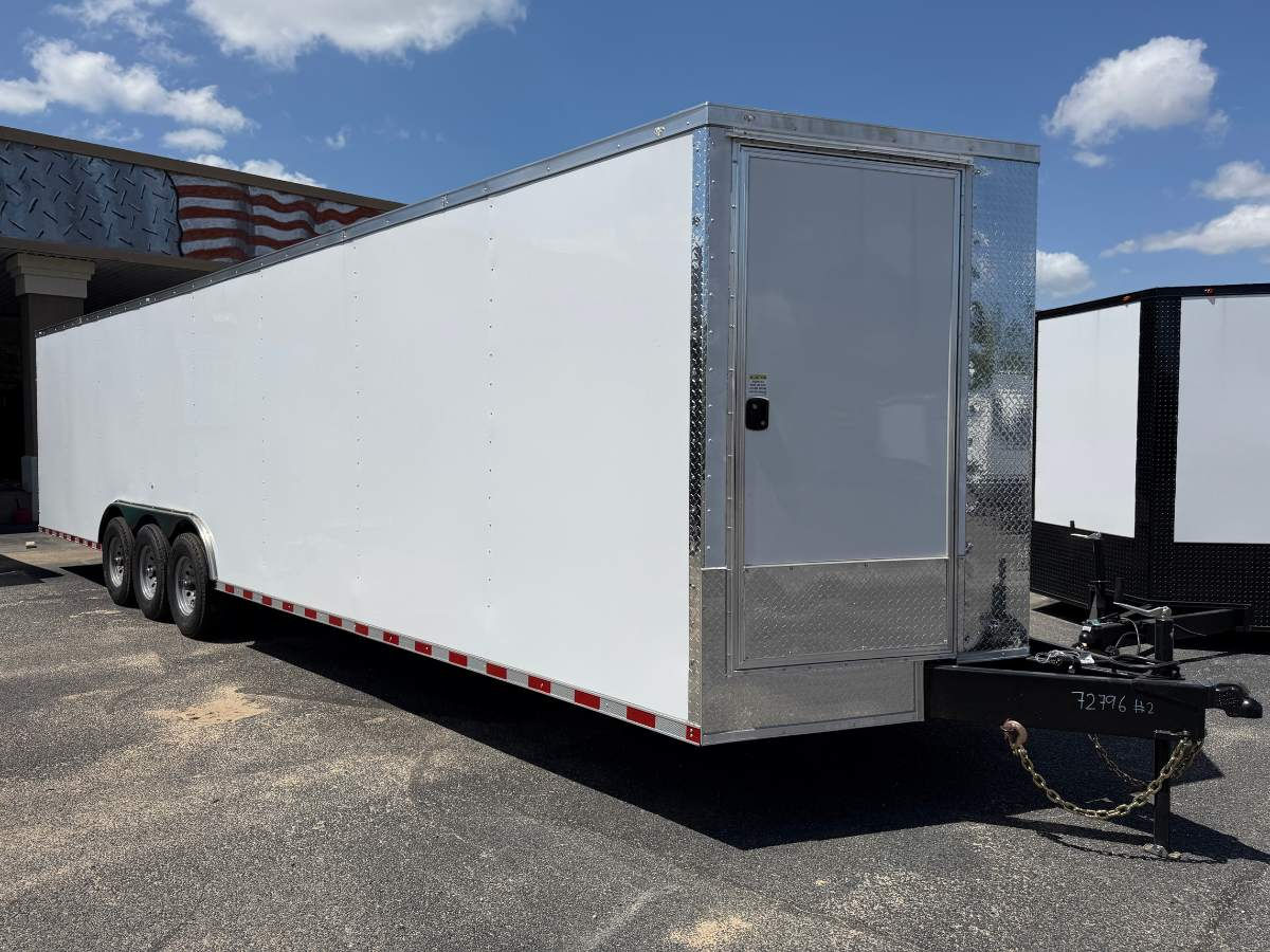 Rock Solid Cargo 8.5x32 triple axle enclosed cargo trailer with white poly exterior, steel floor, torsion axles, vertical E-track, and heavy-duty cargo hauling package.