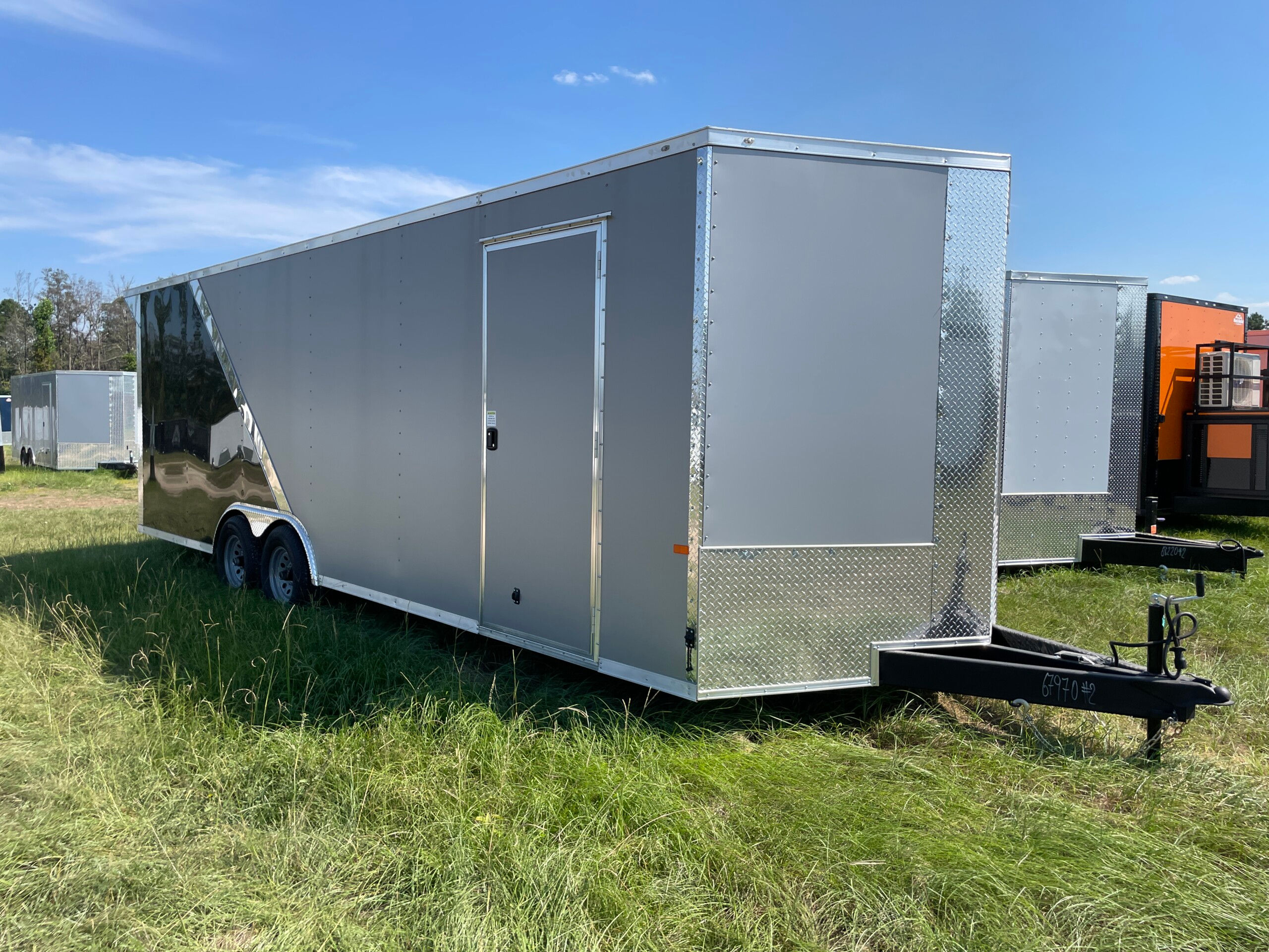 Silver Frost and Black 8.5x24 tandem axle custom enclosed trailer with Polycore exterior, torsion axles, rear spoiler, D-rings, and ramp door